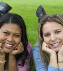stock photo young women laying in grass