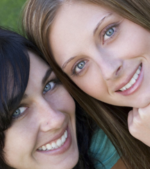 stock photo two young women with beautiful white smiles