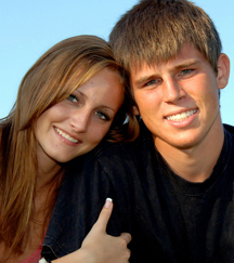 stock photo teen couple sitting outside in grass