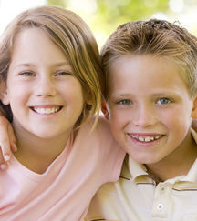 stock photo young brother and sister sitting together outside